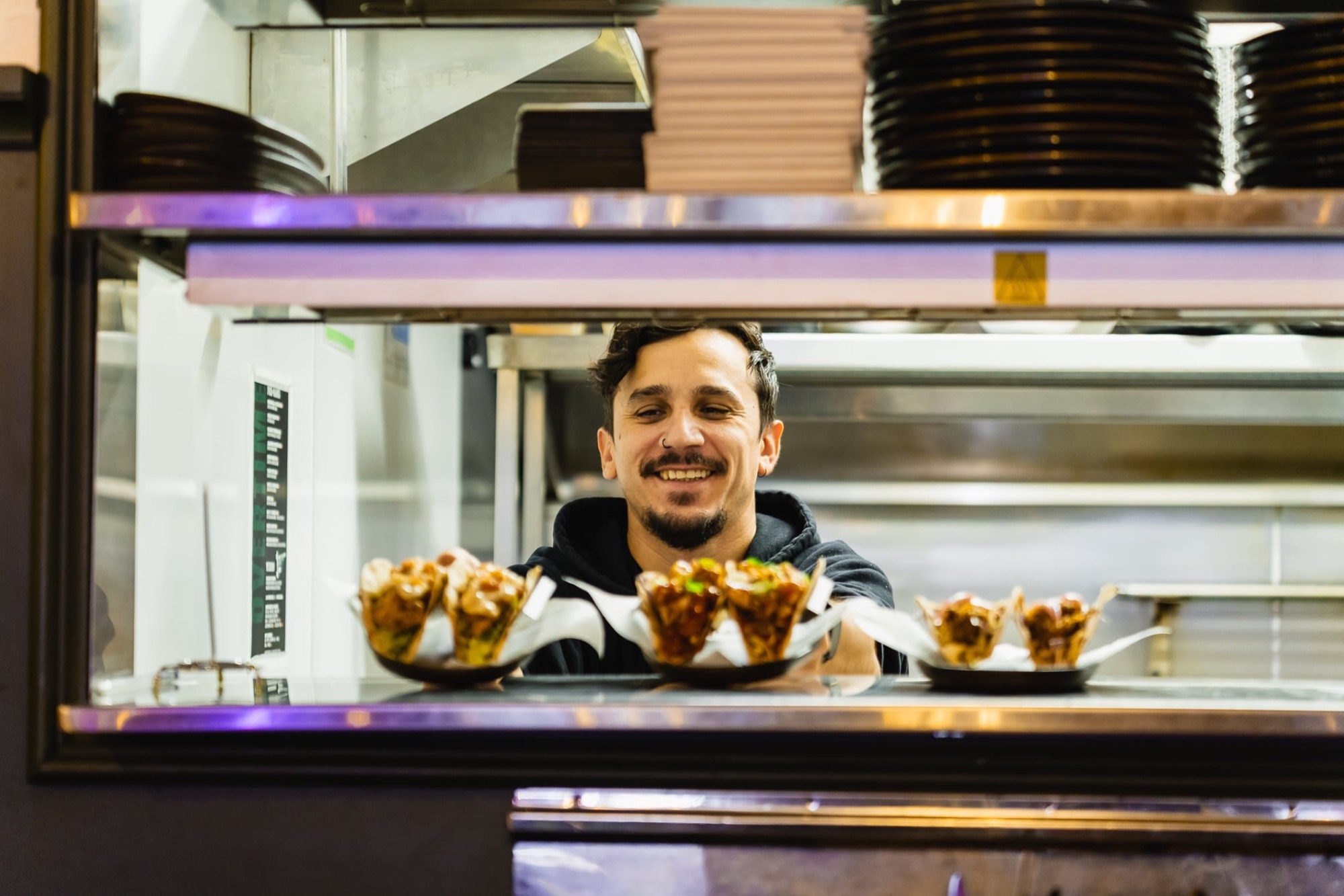Kitchen staff serving up food through the pass at The Locker Room