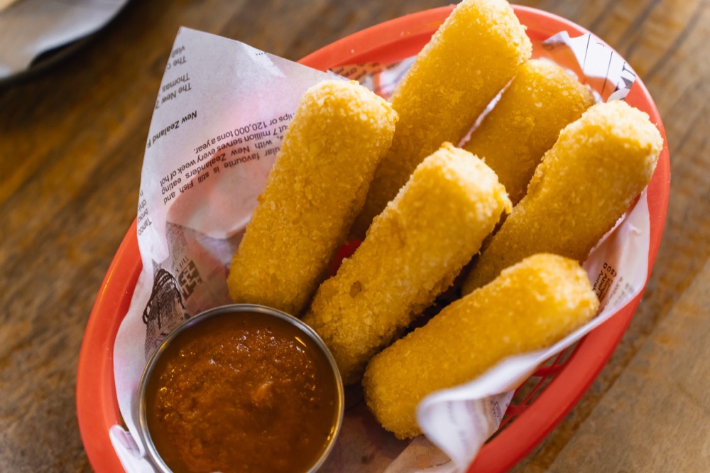 Basket of crumbed fish fingers with dipping sauce at The Locker Room