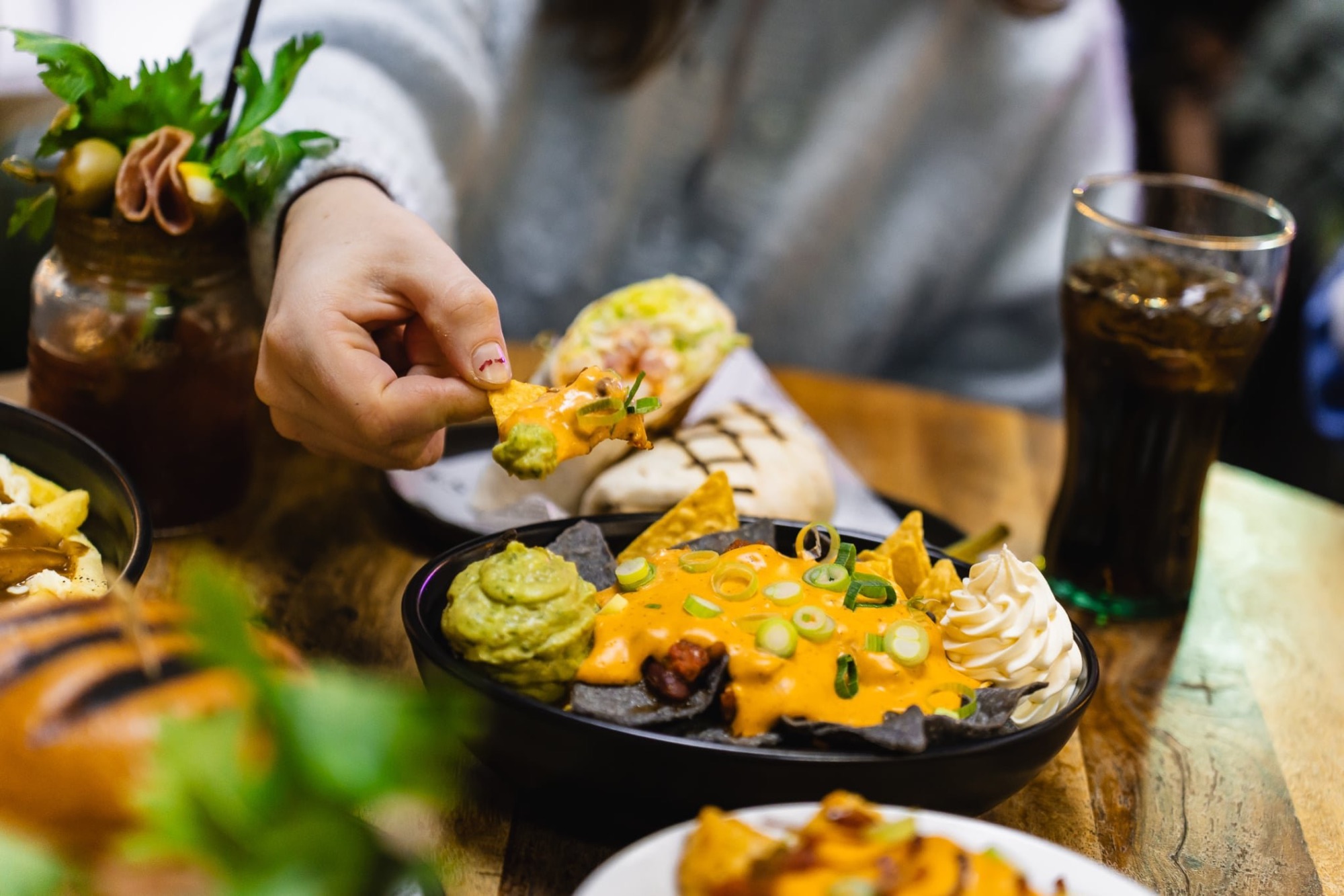 Loaded nachos with cheese sauce and guacamole at The Locker Room
