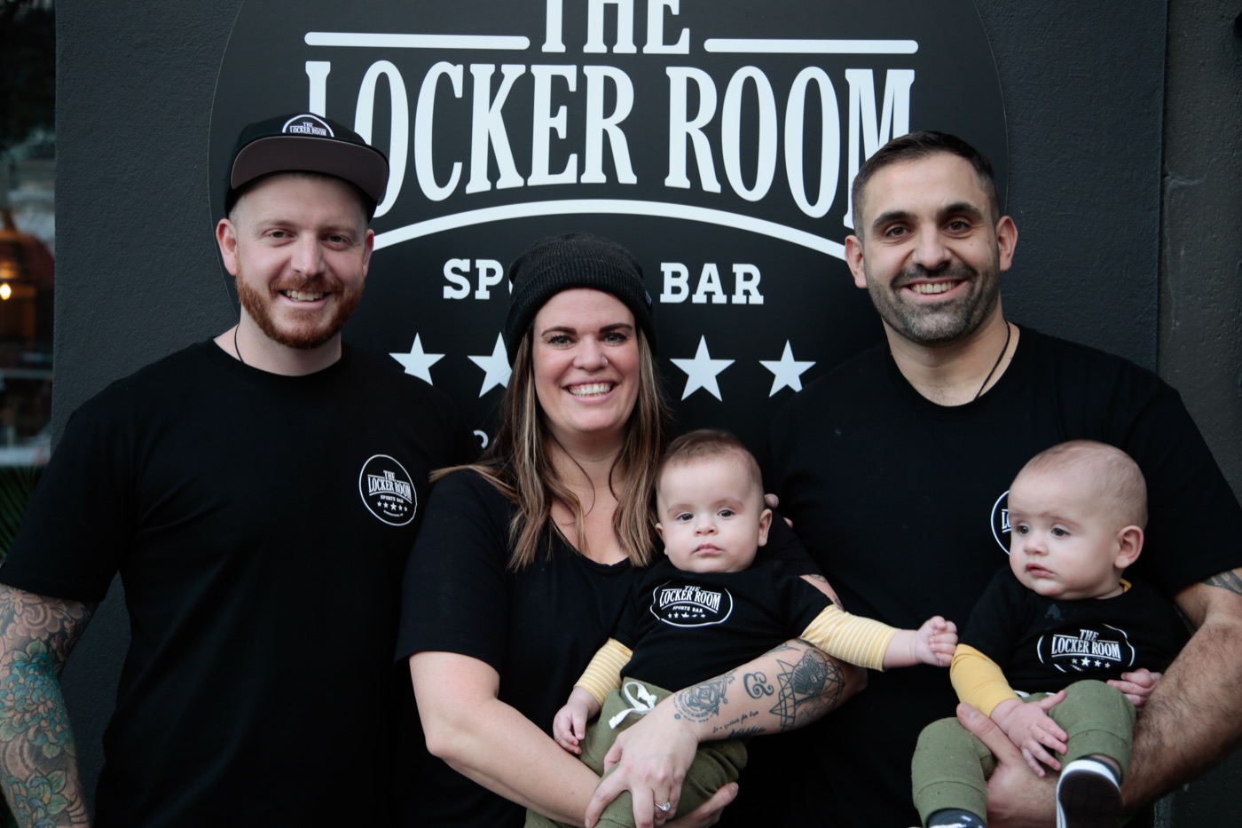 Hayden, Romain, Casady and their twin boys outside The Locker Room Sports Bar