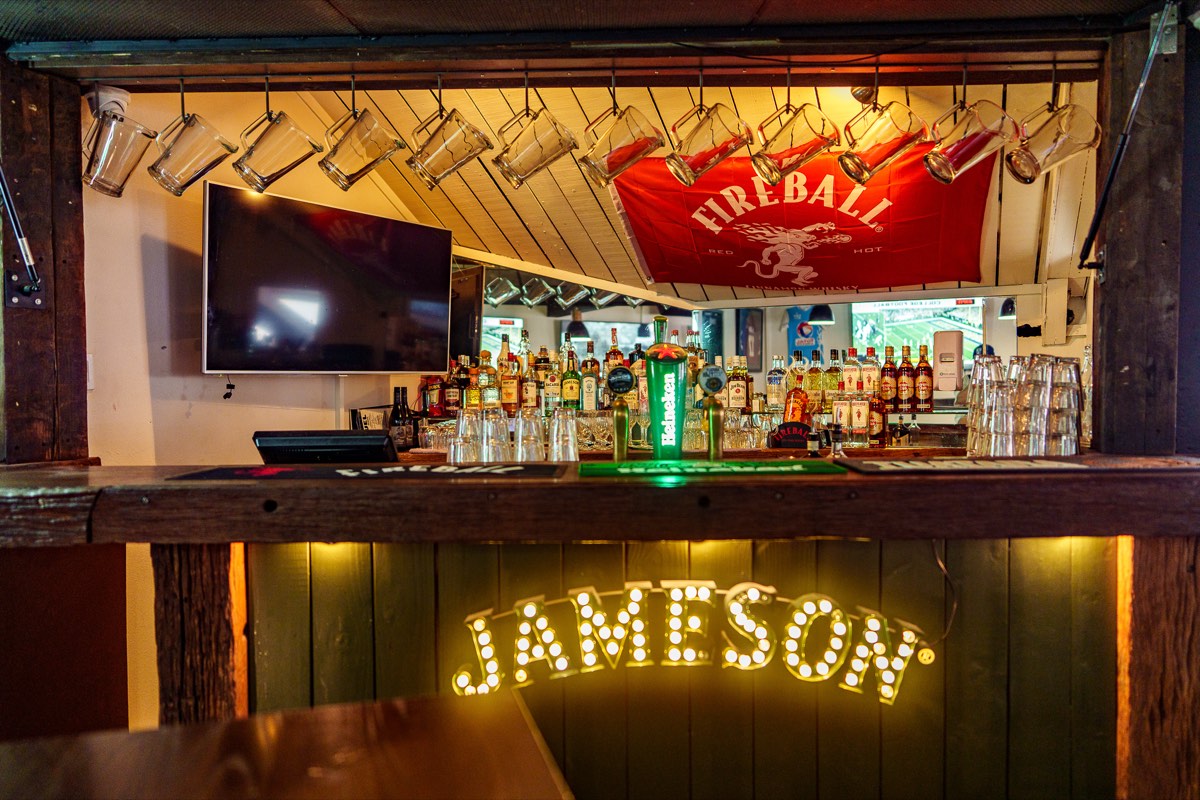 Bar shelf with spirits and taps at The Locker Room